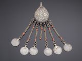 a close up of a silver and coral necklace with coins