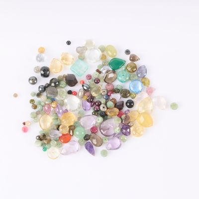 a pile of different colored stones on a white surface