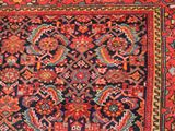 an antique persian rug with a colorful design on a black ground