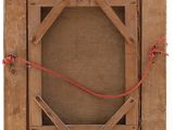 an old wooden picture frame with a red string hanging from it