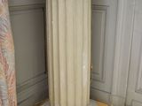 a lamp that is sitting on a pedestal in a room