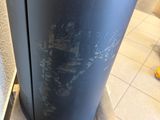 a large black vase sitting on a pallet on the floor