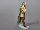 a figurine of a man with a green coat and hat