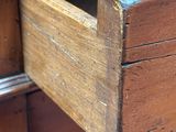 a close up of a drawer with a wooden handle