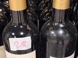several bottles of wine are lined up on a shelf in a store