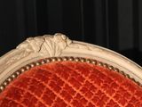 a close up of a chair with a red upholstered seat