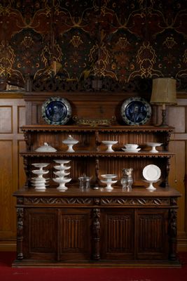 une grande armoire en bois sur laquelle sont posées plusieurs assiettes