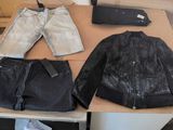 two jackets, a pair of jeans, and a wallet on a table
