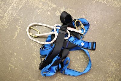 a blue harness and a pair of scissors laying on the ground