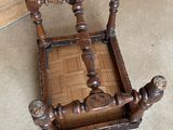 a wooden chair that is sitting on the floor next to a door