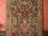a large tapestry hanging on the wall in a room