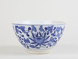 blue and white bowl with a flower design on the side