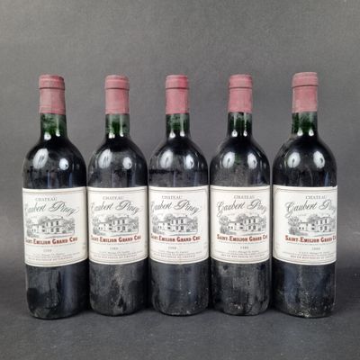 four bottles of wine are lined up in a row