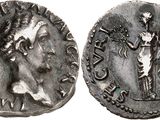 a silver coin with an image of a man holding a sword