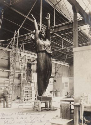 an old black and white photo of a statue in a building