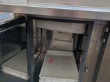 a small oven with a tray inside of it