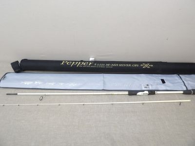 a close up of a fishing rod on a table next to a bag