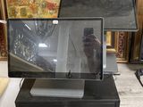 a laptop computer sitting on top of a black desk