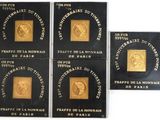 four gold coins with a picture of a man on them