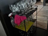 many wine glasses on a cart in the room