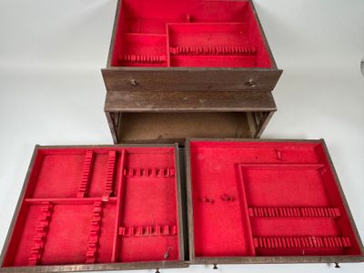 three wooden boxes with red linings are sitting on a white surface