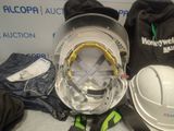 a hard hat, helmet, and other items on a table