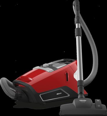 a red vacuum cleaner with a black handle on a black background