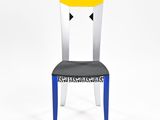 a close up of a chair with a yellow seat on a white background