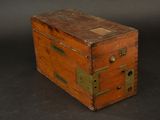 a small wooden box with a metal latch on it