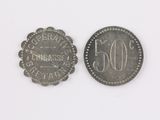 an old coin with the number 50 on it next to a smaller coin