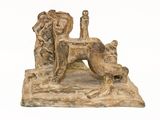 statue of a dog with a man and a woman sitting on it