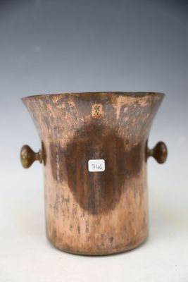 an old copper vase with handles on a white surface