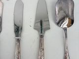 a lot of silverware on a table with spoons and knives