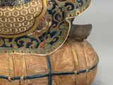 a figurine of a man sitting on top of a basket
