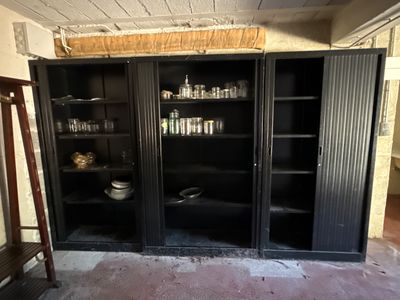 a black cabinet with glass doors in a room
