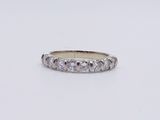a close up of a diamond ring on a white surface