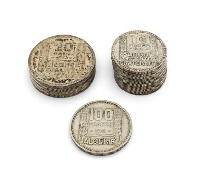 three silver coins sitting on top of each other on a white surface