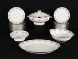 a lot of plates and bowls on a black table