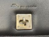 a close up of a black leather purse with a metal latch