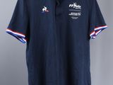 a blue polo shirt with a red, white and blue stripe around the collar