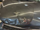 a car that has been dented and is parked in a garage