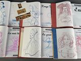 a lot of books that are open on a table