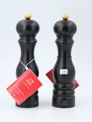 two black pepper grinds with tags on them sitting on a white surface