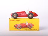 a red toy car and a red toy car on top of a yellow box