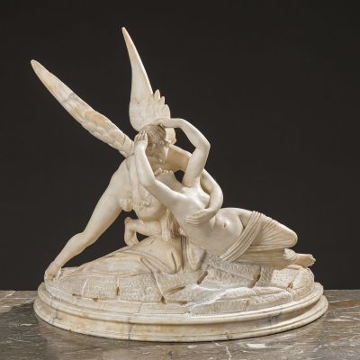 an image of a statue of a woman and a man on a rock