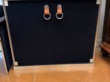 a black cabinet with two handles on it in a kitchen