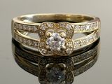 a close up of a diamond ring on a reflective surface