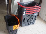 two black and red baskets sitting next to each other on the floor
