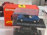 three model cars in a display case on a table