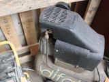 a small air compressor sitting on top of a pallet